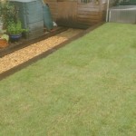 Garden levelled and turfed, with timber sleeper retaining wall and gravel path that also allows for drainage to stop the flooding problem owner previously experienced.