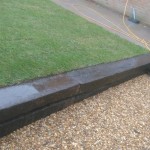 Garden path with railway sleeper retaining wall